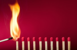 Burning match setting fire to its neighbors